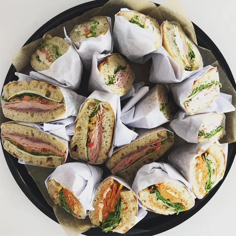 Wrapped Mae's sandwiches ready for catering